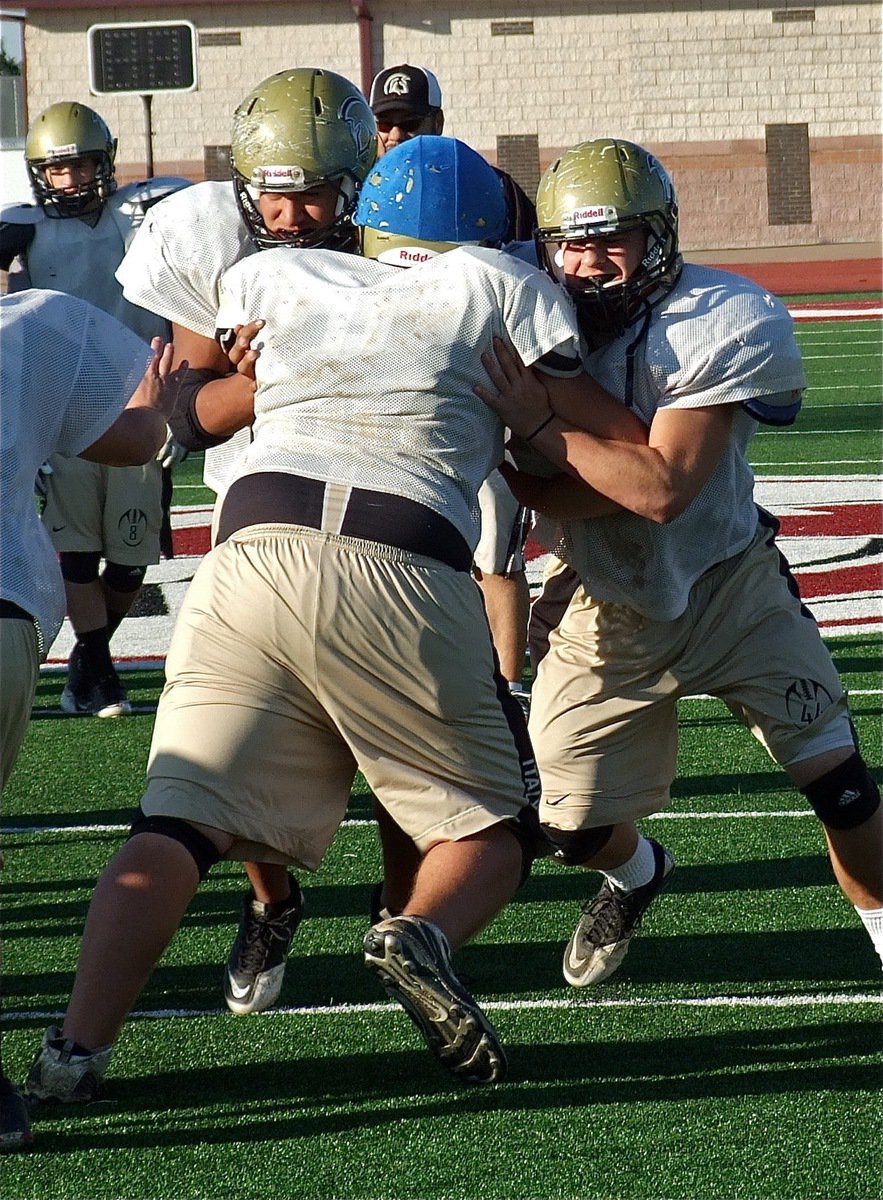 Image: Left tackle Omar Estrada and tight end Ethan Saxon execute a double-team block.