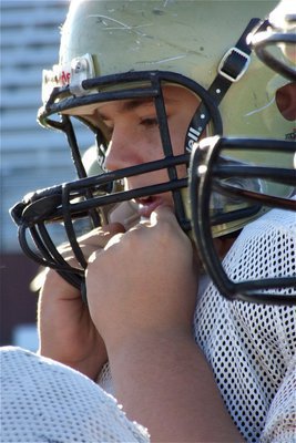 Image: Kelton Bales pulls his headgear on a little tighter for the playoff game against Franklin.