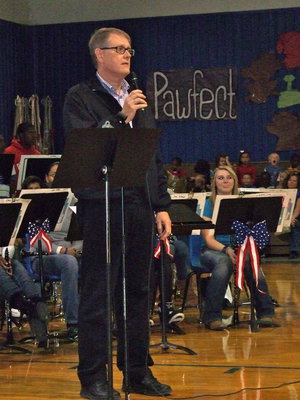 Image: Alton Chambers inviting veterans and individuals with family members who have served in our nation’s military to stand during the song for their branch of service.