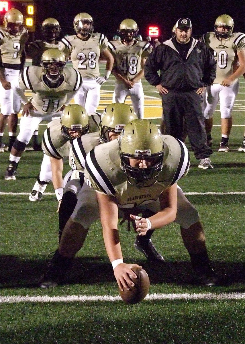 Image: Gladiator head coach Craig Bales monitors the timing of his offense during the pre-game warmups.