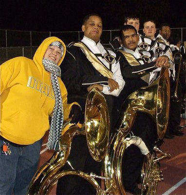 Image: Assistant Band Director Erica Scott tries to stay warm while Timothy Fleming, Yonathan Davila, Zac Mercer, Nolan Griffith and John Hughes get ready to perform at halftime.