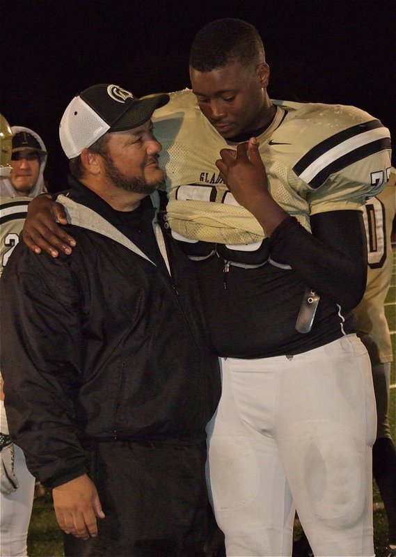 Image: Coach Bales congratulates senior lineman Larry Mayberry, Jr. for his great career.