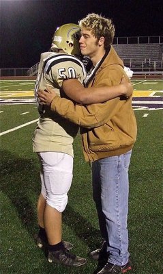 Image: Senior center Brandon Souder(63), who was injured early in the season, hugs his replacement sophomore Zain Byers(50) after the loss to Franklin. Displaying an example of leadership and teamwork, Souder supported his understudy every snap of the way.