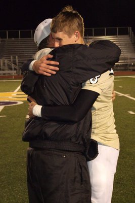 Image: Coach and quarterback. One of the strongest bonds in sports, Coach Bales congratulates senior Jase Holden(3) for a job well done having never played the position before.