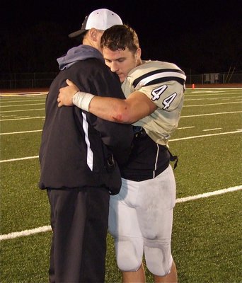 Image: Gladiator Assistant coach Aidan Callahan shares a moment with senior linebacker/tight-end Ethan Saxon(44) after Italy’s playoff loss to Franklin.