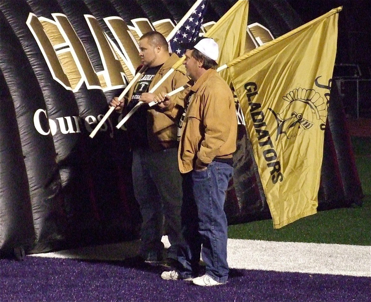 Image: Andy Saxon and Lee Hamilton have the ceremonial flags ready for the players.