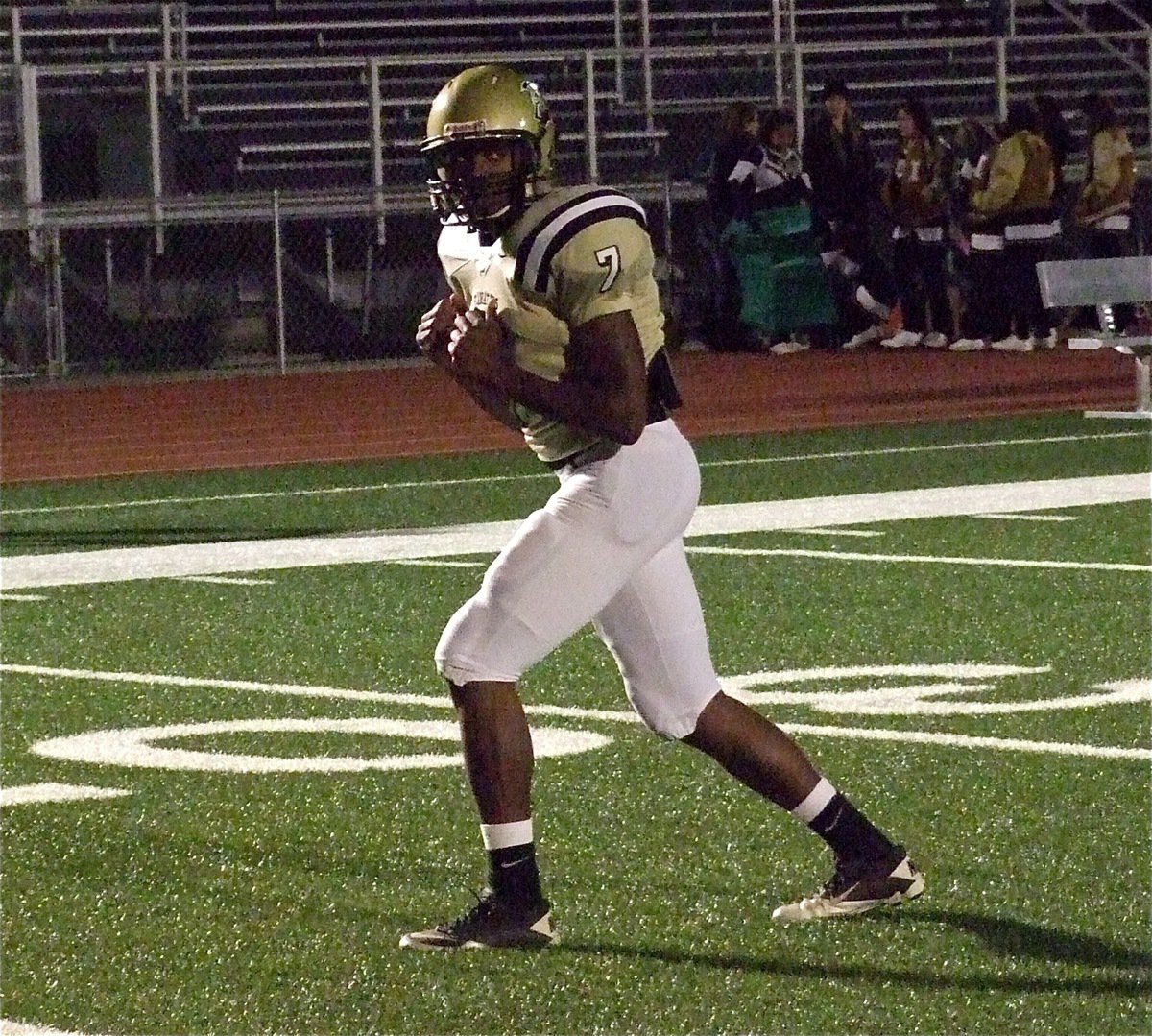 Image: Gladiator Paul Harris(7) runs his receiver route during pre-game warmups.