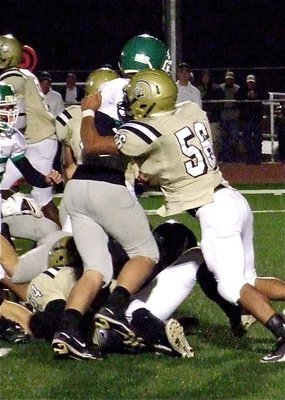 Image: Italy’s senior left tackle Omar Estrada(56) tries to drive a Franklin defender away from the ball.