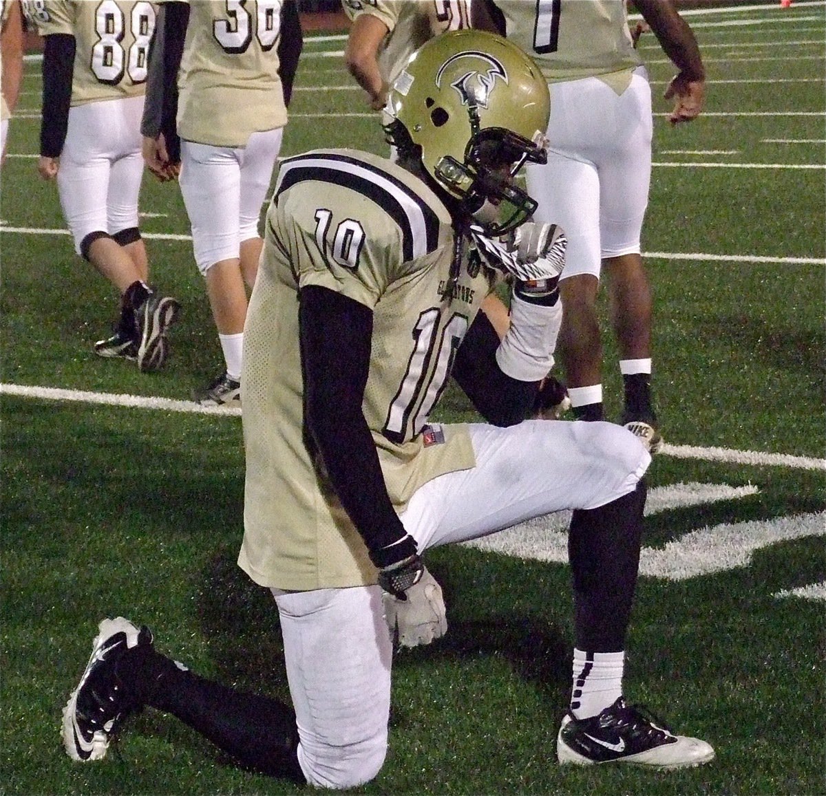 Image: Ryheem Walker(10) collapses to one knee as the realization that the season has ended overtakes him.