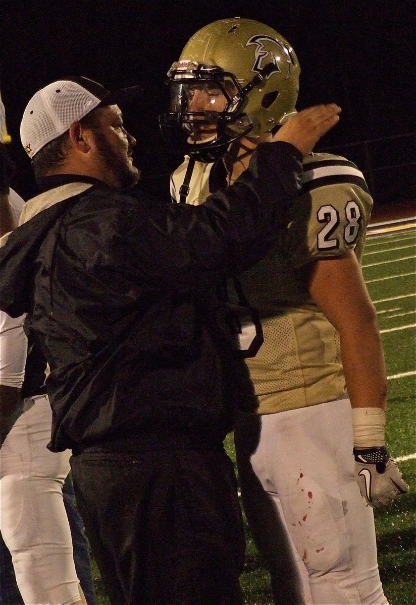 Image: Coach Bales takes a moment with his senior linebacker/fullback Kyle Jackson(28).