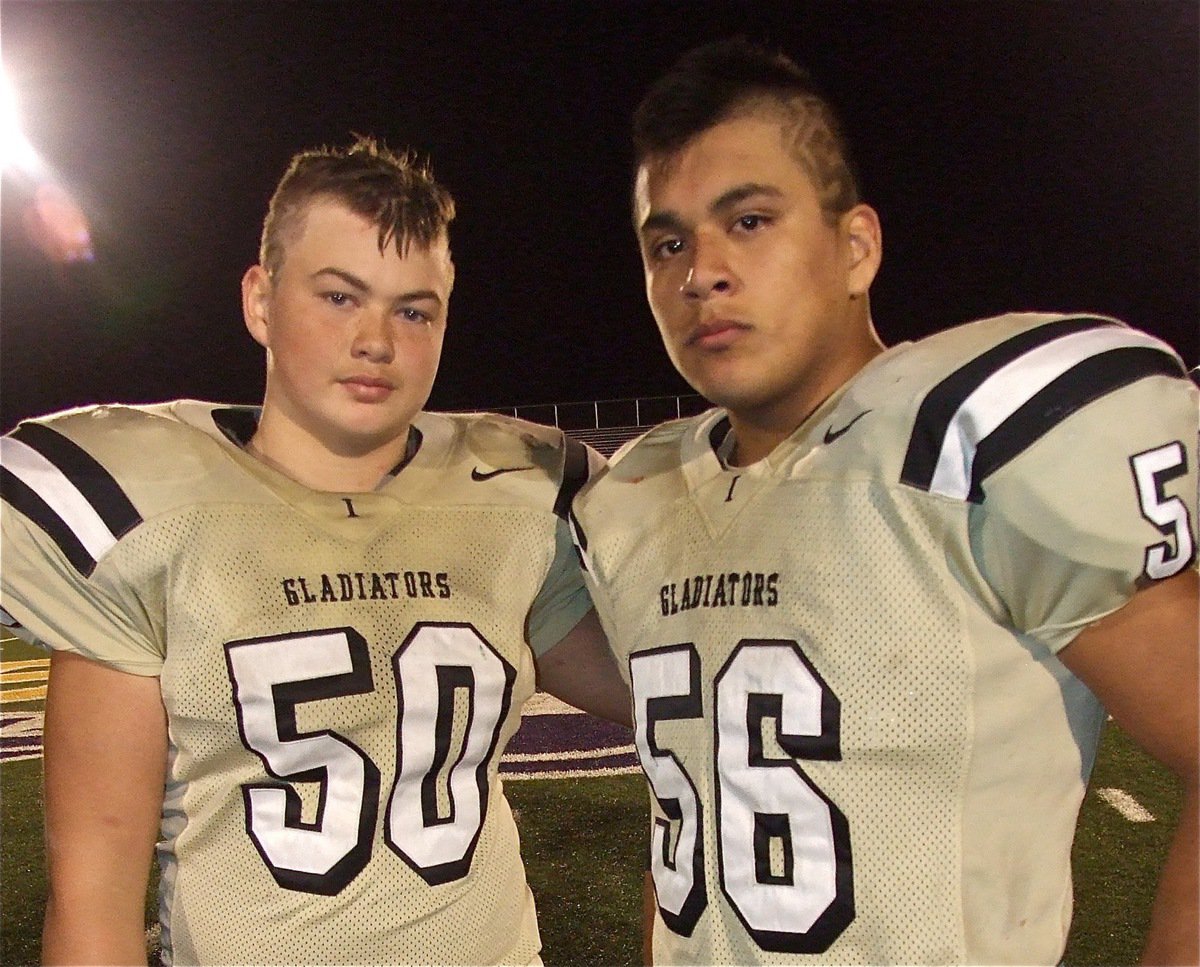 Image: Mentor and rookie. Senior lineman Omar Estrada(56) began his career as a sophomore for the Gladiators and served as mentor this season to sophomore Zain Byers(50) who was thrust into action before Italy’s pre-season game against Mart. “Thank you, Omar.”