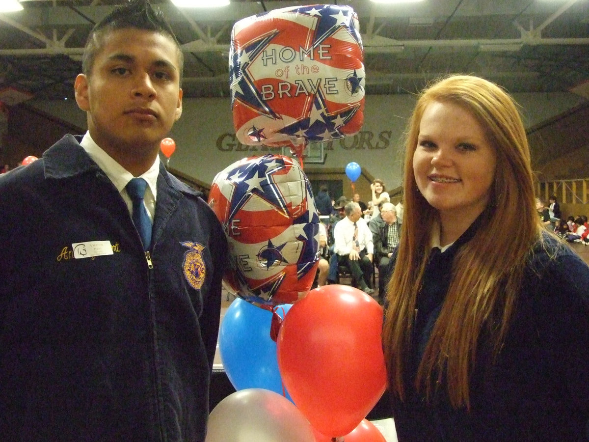 Image: Omar Estrada and Katie Byers present the colors to the audience.