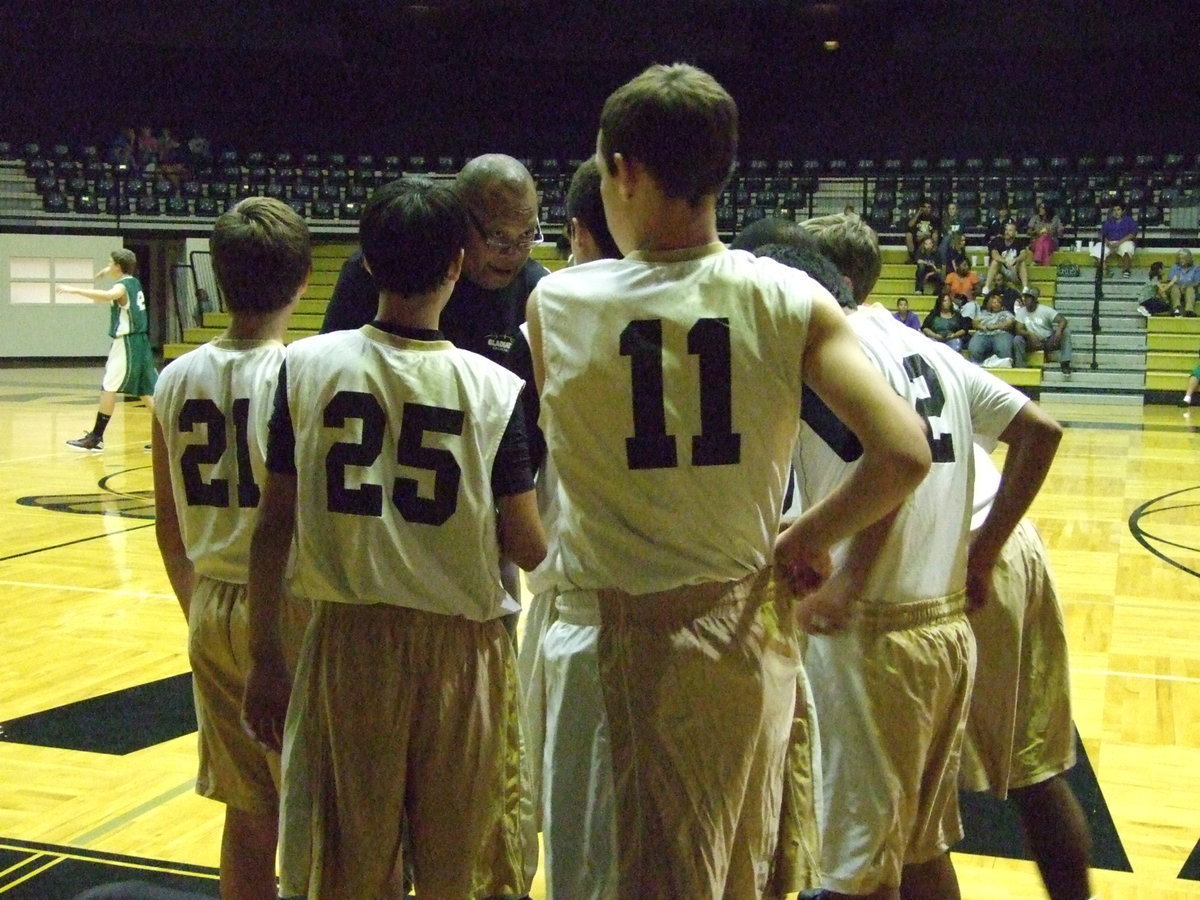 Image: Coach Larry Mayberry lets the 8th grade team know how serious this game is.