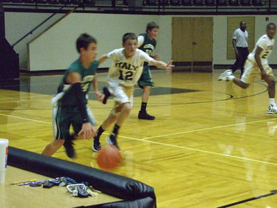 Image: 
    	Ty Windham follows the ball down the court.
    