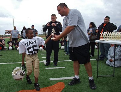 Image: Damorian Sargent(55) accepts his Superbowl runner-up trophy from his head coach, Aaron Itson.
