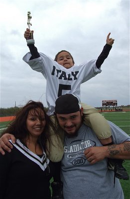 Image: On the shoulders of his parents Rosanna and Bobby Wooldridge, Italy C-Team Gladiator #5 Damien Wooldridge (Pre-K) expresses how we all felt after the Superbowl game. Although, Ferris won in the end 21-6, It was a great day for IYAA Football and Chearleading.