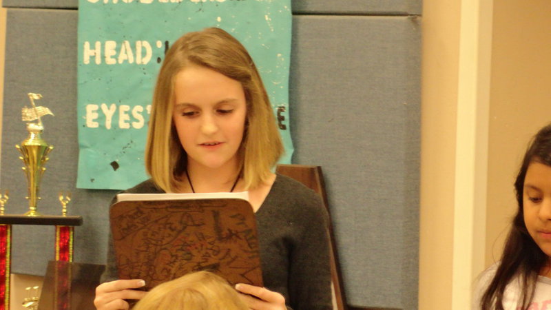 Image: Kirby Nelson reads a poem she learned in sixth grade.