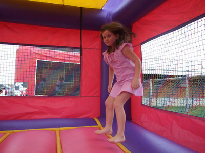 Image: Brianna Hall has fun jumping in the bounce house at the community event.