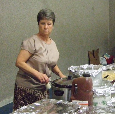 Image: Donna Goodwin from Central Baptist Church helps serve the food.