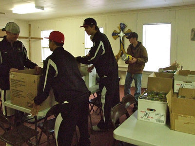 Image: Moving boxes and separating food was a big priority for NHS at the food pantry.