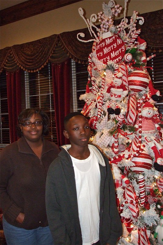 Image: Chasston Wilson and his mother Stephanie Wilson participate in the toy drive for the Italy Christmas Festival inside the Haight home.