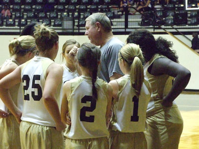 Image: Lady Gladiators listen to Coach Randy Parks for last minute plays.