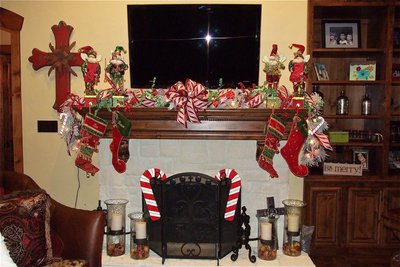 Image: Elaborately decorated mantel complete with stockings and candy canes. Even the camera flash was in the holiday spirit.