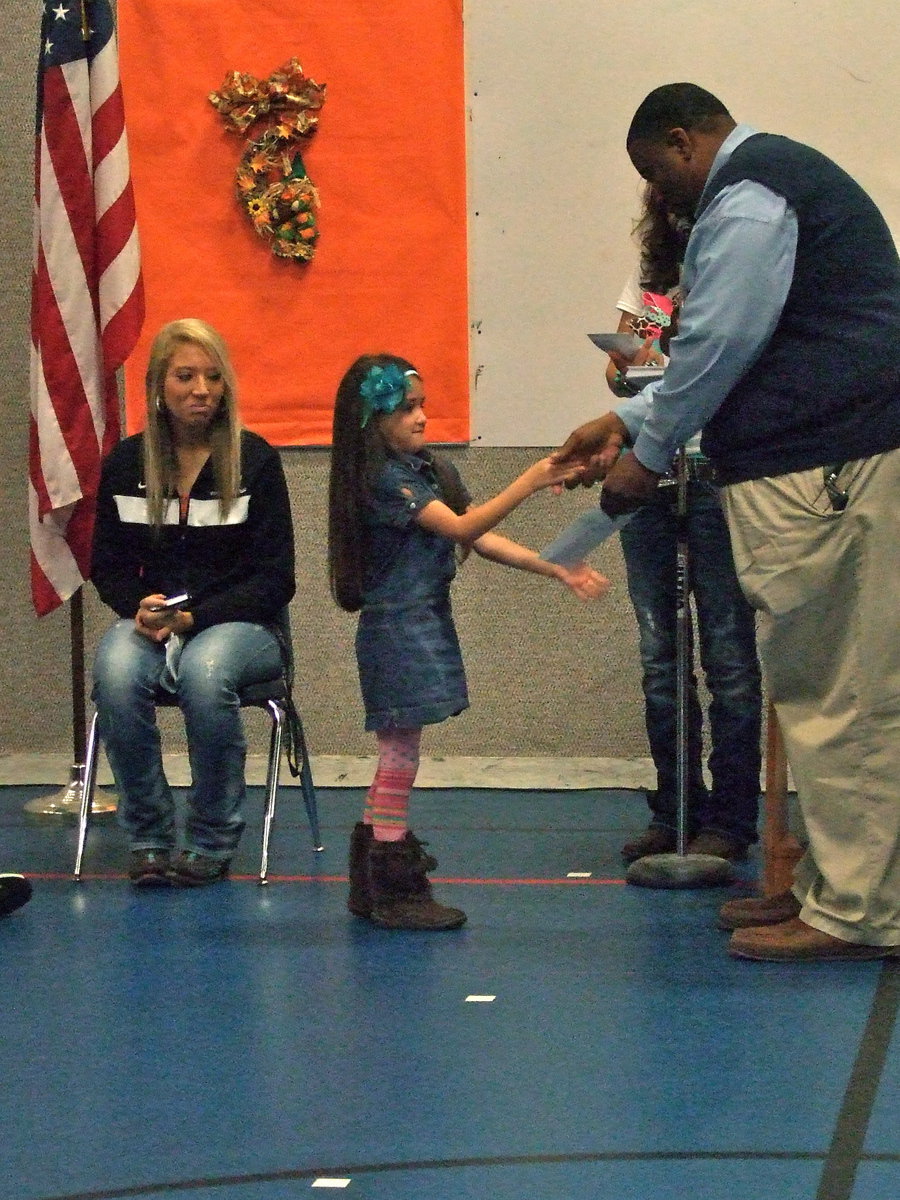 Image: Big smile for Mr. Miller as this student gets her perfect attendance award.