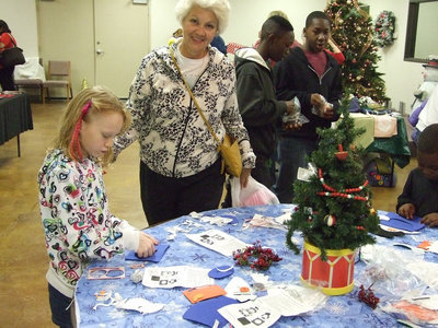Image: Alice and granddaughter, Angel, enjoy the day making crafts in the community center.
