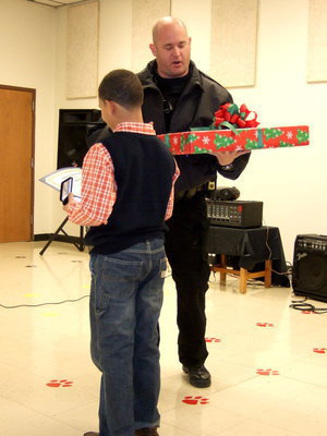 Image: Italy Police Officer Martin presented Dylan with the Life Saving Award and a big Christmas present.