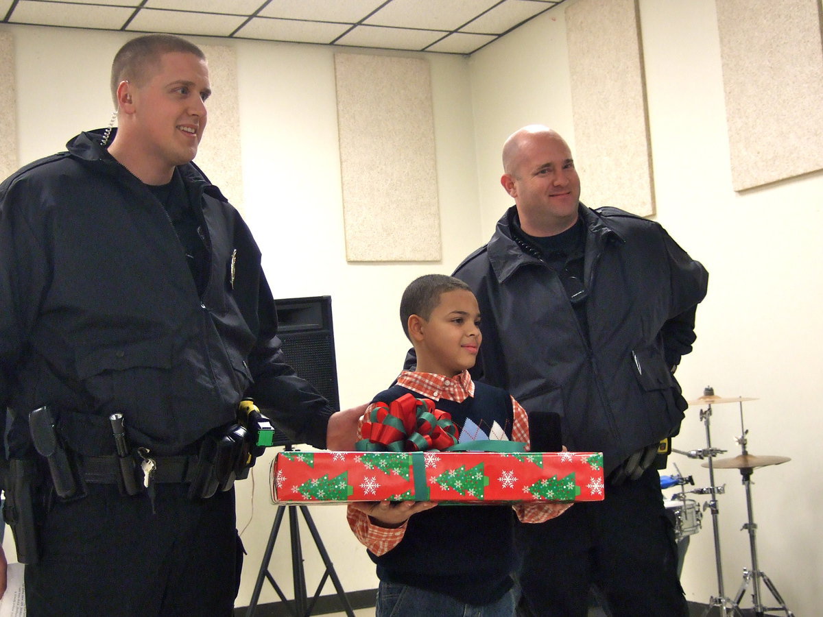 Image: Officer Richards, Dylan Monk and Officer Martin stand proud.