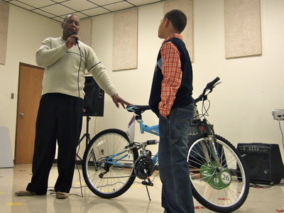Image: Minister Johnny Johnson presented a bike to Dylan from the Refiners Fire Ministries in Ennis.