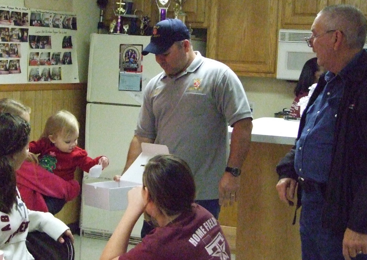 Image: A sweet volunteer pulls the name for the door prize.