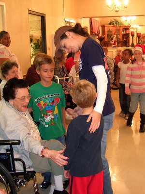 Image: Students and Mom visiting with the residents.