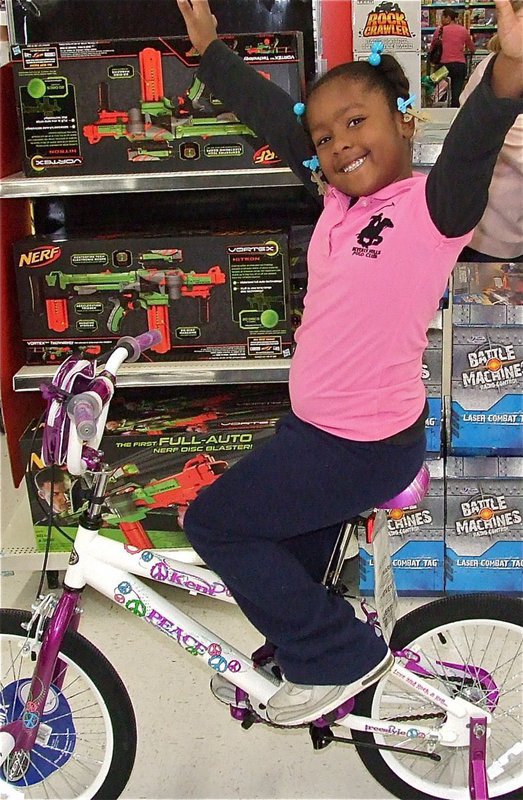 Image: Mission accomplished! Mariah shows her excitement on her new bicycle she picked out for Christmas.