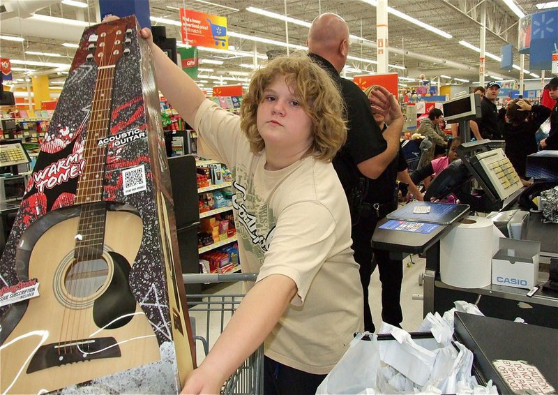 Image: Stafford Elementary 6th grader Tomi Newman displays her new acoustic guitar she picked out for Christmas.