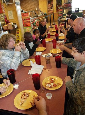 Image: All that shopping really works up an appetite. Officers and students enjoy the lunch buffet at Pizza Inn® in Italy.