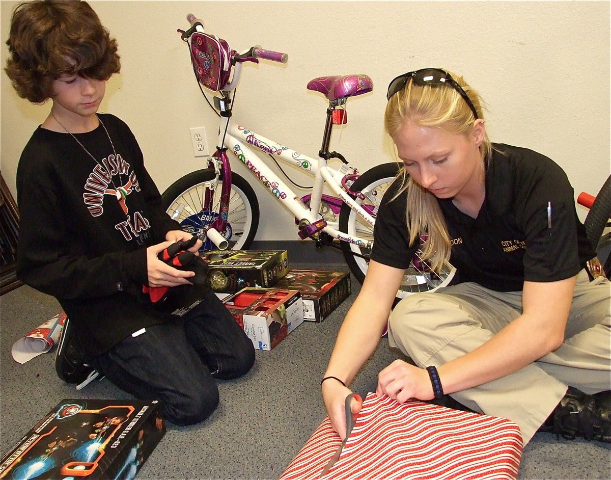 Image: Animal Control Officer Shelbi Landon shows Nicholas how not to wrap a present and then shows him a better way to wrap his presents.