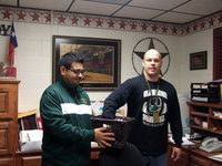 Image: Jesus Perez (Italy ISD band director) holds the basket as Lee Joffre pulls out the names of the lucky winners.