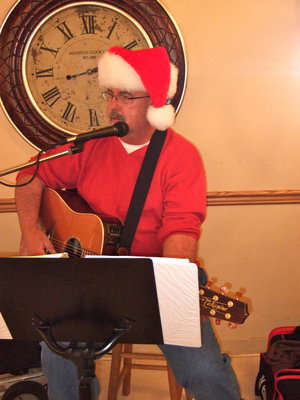 Image: David Lowrey is making the Christmas party a success by singing lots of Christmas songs.