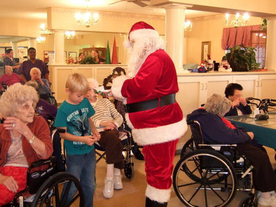 Image: Santa is busy handing out candy canes to residents and guests.