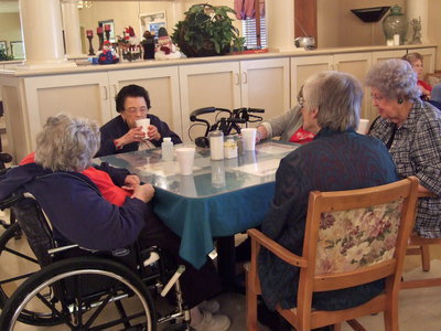Image: These residents are enjoying their punch while waiting on their Christmas lunch.