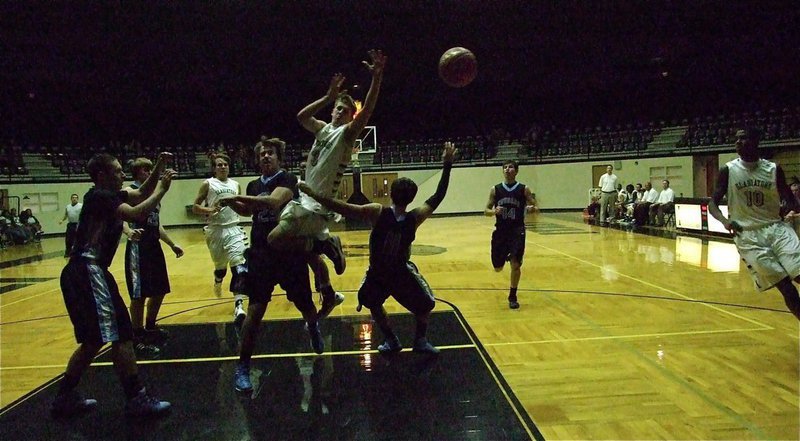 Image: Gladiator point guard Jase Holden(3) is fouled driving to the rim.