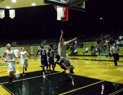 Image: JV Gladiators John Byers(33) draws a defensive foul against ROLOC on his way to the rack.