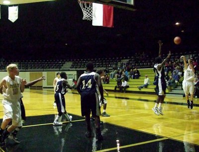Image: John Escamilla(3) takes a three-pointer from the corner against Red Oak Life Oak Cliff.