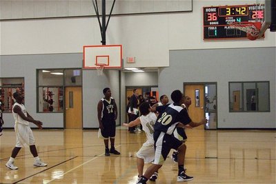 Image: JV Gladiator Marvin Cox(1) swishes a free shot.
