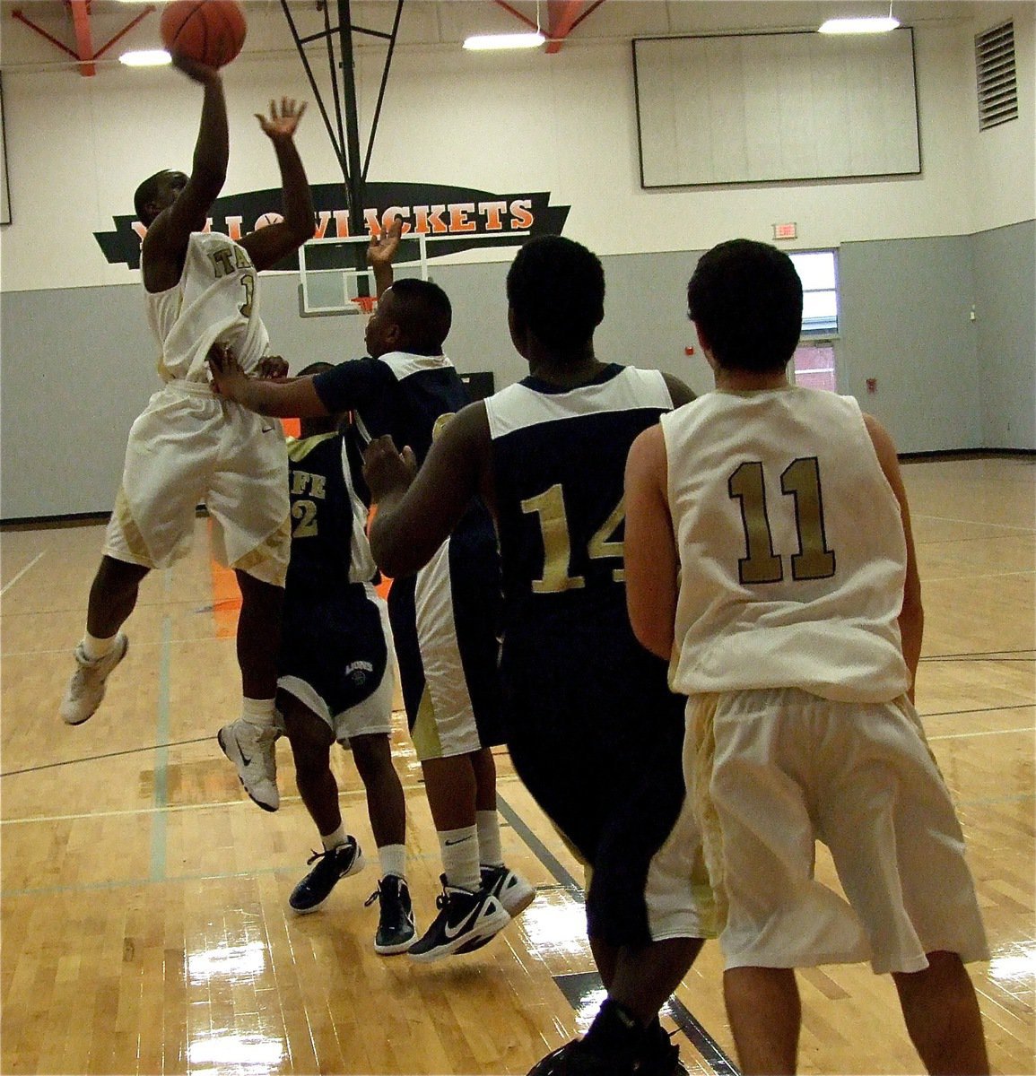 Image: Marvin Cox(1) hits a mini jumper over the Lions.