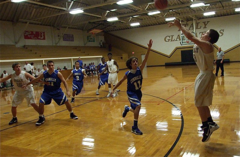 Image: John Escamilla(3) shoots a three ball against Conally’s JV in the old Italy gym.