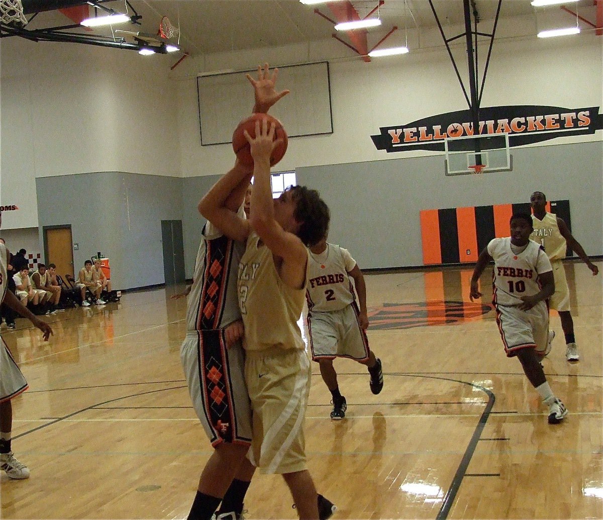 Image: Chace McGinnis(12) finds a way to score against the Ferris big man.