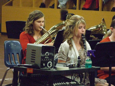 Image: 8th grader Halee Turner on clarinet and Lillie Perry plays baritone as the band presents “Feliz Navidad” at the Christmas concert.